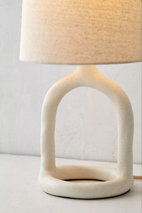 Boho texture brings an inviting touch to this minimalist table lamp. Features a cutout resin base with curving shaping, topped by a subtly angled woven fabric shade. Plugs in to power on. Exclusive to Urban Outfitters. Features - Resin table lamp - Plug-in - Requires 60W Type A bulb - not included - Shade included - Compact fluorescent compatible Content + Care - Resin, fabric - Wipe clean - Imported - Made in compliance with US electrical standards. To use this item outside of the US, pair wi Boho Nightstand, Minimalist Table Lamp, Resin Fabric, Boho Lamp, Boho Texture, Minimalist Table, Ceramic Pendant Light, Bed Lamp, Table Lamps Living Room