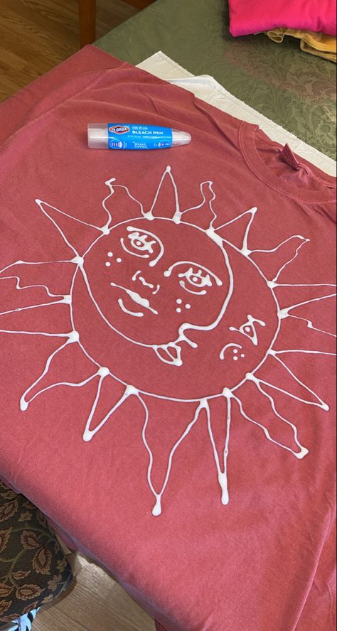 Using a Clorox bleach pen to hand draw a simple design to bleach through on a tshirt. Inspired by trippydraws Sun And Moon Bleach Shirt, What To Draw On A Tshirt, Bleach Art Clothes Aesthetic, Sweatshirt Bleach Design, Bleach Painted Sweatshirt, Bleach Jumper Design, Tshirt Bleaching Ideas, Cool Bleach Designs, Bleach Sweatshirt Designs