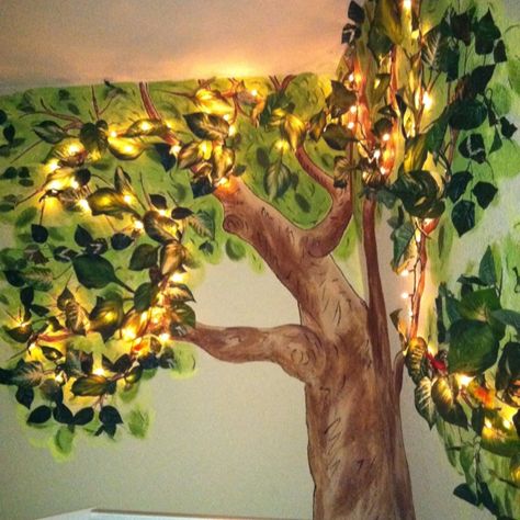 Connor's nightlight tree: in his nursery I painted a tree, then strung mini lights with brown wire (meant for a wooden rustic wreath), then stapled multiple sized silk leaves for a 3D effect and a green glow. Nursery With Tree Mural, Forest Wall Mural Painted Bedroom, Tree Murals On Wall Diy, Zelda Themed Nursery, Woodland Mural, Diy Moss, Forest Room, Sustainable Flowers, Tree Wall Murals