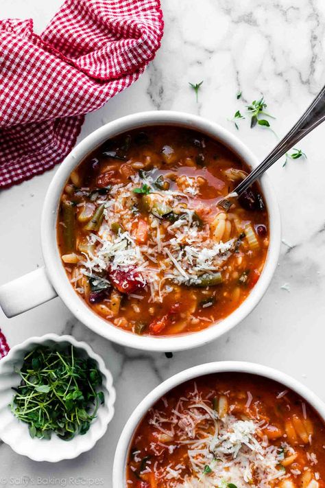 This hearty minestrone soup is thicker than most minestrone soup recipes. Brimming with colorful vegetables, protein-rich beans, and aromatic herbs, it's as delicious as it is satisfying. Feel free to add rice or pasta to the soup, too, and serve it with a slice of rustic homemade bread for a filling vegetarian meal. You'll love this minestrone soup's uniquely rich texture—every spoonful is different! Recipe on sallysbakingaddiction.com Minestrone Soup Recipes, Homemade Bread Bowls, Minestrone Soup Recipe, Vegetarian Protein, Italian Pasta Dishes, Frozen Green Beans, Colorful Vegetables, Sally's Baking, Minestrone Soup