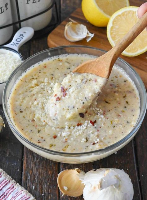 Using a wooden spoon to stir a bowl of garlic parmesan sauce. Wild Wings Garlic Parmesan Sauce, Copycat Buffalo Wild Wings, Garlic Parm Sauce, Best Wing Sauce, Wings Garlic Parmesan, Parmesan Sauce Recipe, Parmesan Wing Sauce, Chicken Wing Sauce Recipes, Chicken Wing Sauce