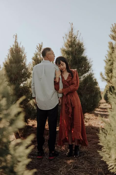 Tree Farm Couple Photoshoot, Christmas Pictures At Tree Farm, Couple Holiday Cards Photo Ideas, Plus Size Engagement Photos Outfits Winter, Christmas Tree Farm Couples Photos, Christmas Tree Lot Photoshoot Family, Christmas Mini Sessions Couples, Couples Tree Farm Photoshoot, Couple Christmas Tree Farm Photos