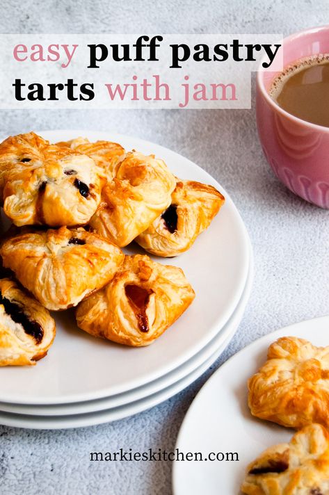 A picture of puff pastry tarts filled with jam served on a plate next to a cup of coffee. Puff Pastry With Jam Recipe, Puff Pastry Apricot Jam, Jam Tarts With Puff Pastry, Jam Filled Pastries, Jam And Puff Pastry, Puff Pastry Jam Recipes, Puff Pastry Jam Tarts, Jam Puff Pastry Recipes, Jam Tarts Recipe Simple