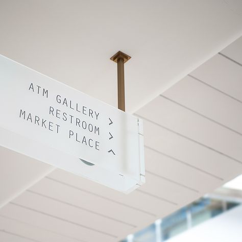 Overhead directional signage in frosted glass, with copper coloured metal… Glass Signage, Signage Wayfinding, Wayfinding Signage Design, Office Signage, Store Signage, Wayfinding Signs, Directional Signage, Retail Signage, Sign System