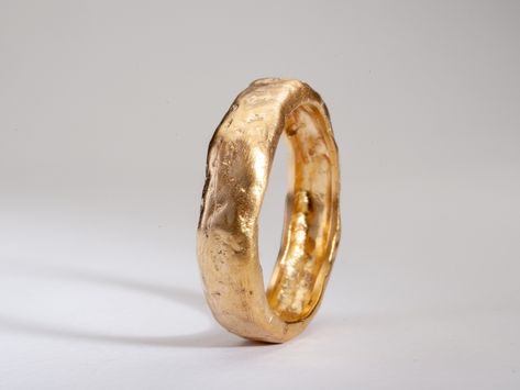 Details:  RMY698  Weight: about 4g  Thickness: 2.1-2.2 mm (hollowed)  Width: about 6 mm  14k solid yellow gold This chunky gold wedding band has a unique hammered and textured surface. This ring has an organic gold finish which looks like melted gold. A truly unique gold band with lots of personality and style! Great for both men and women.  ◈ ALSO AVAILABLE IN  14K in yellow, rose and white gold 18K Rose and White Gold  22K Solid Yellow gold  ◈ ENGRAVING is optional for $7 per letter/number/character. Please pay using the engraving order form at this link: https://www.etsy.com/il-en/listing/1067854382/personalisation-engravings?ref=shop_home_active_1&frs=1&crt=1 Please note that engraved jewellery cannot be exchanged or returned ◈ SHIPPING is insured express and free worldwide ◈ GIFT WRAP Ring Texture, Wedding Band Thick, Hammered Wedding Band, Minimalist Wedding Band, Chunky Wedding Band, Organic Gold Ring, Textured Ring Band, Thick Wedding Bands, Textured Gold Ring