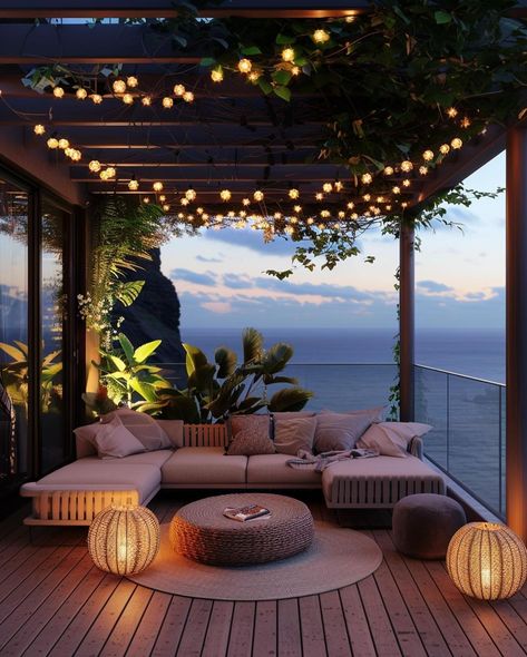 This pin depicts a beautifully designed outdoor lounge area at twilight. The space features a large, L-shaped sectional sofa with soft beige cushions.Hanging above the lounge area are strings of small, warm, globe-shaped fairy lightstwo spherical lanterns with a wicker design emit a warm light, adding to the inviting ambiance. Large Balcony Ideas House, Large Balcony Ideas Terraces, Balcony Fairy Lights, Penthouse Terrace Ideas, Large Balcony Ideas, Dark House Exterior, Apartment Views, Dream Balcony, Balcony Oasis