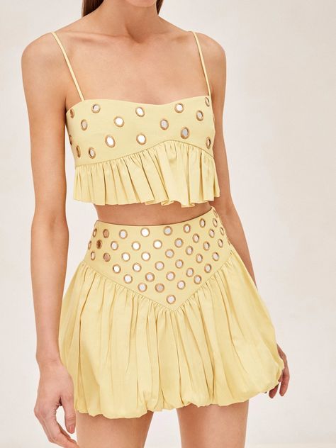 Featuring a soft yellow hue, intricate ruffled hem, and glimmering mirrored details, the Liane Top offers a captivating charm. Whether paired with the Zinn Skirt for a coordinated look or dressed down with high-waisted denim, this top effortlessly adds a touch of casual elegance to any outfit. Haute Couture, Coachella Mini Dress, Colorful Two Piece Set, Daily Drills Outfit, Summer Soiree Outfit, Cute Outfits For Italy, Different Clothing Aesthetics Types, Going Out Tops College, Khaki Color Outfit