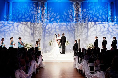 Transform your wedding into a winter wonderland by projecting a wintry scene onto your backdrop. Projector Wedding, Gobo Lighting, Jewish Wedding Traditions, Winter Candles, Winter Backdrops, Wedding Themes Winter, Winter Wedding Decorations, Wedding Ceremony Backdrop, Bridal Guide