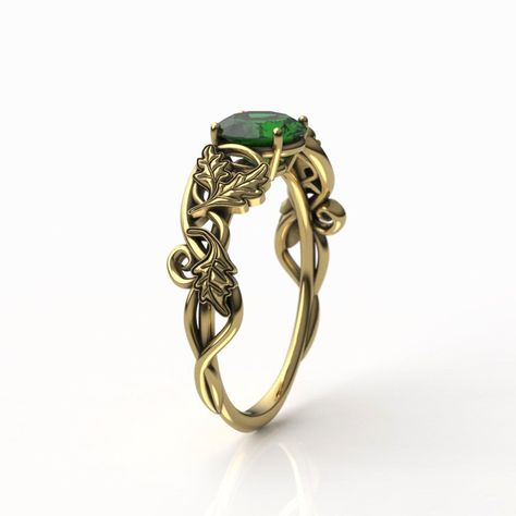 "To see our entire Elven collection, click here: https://www.etsy.com/shop/MetalWendler?ref=seller-platform-mcnav&search_query=elvish This Woodlands Oak Leaf Fantasy themed engagement ring is made from recycled gold and is handmade with a comfort fit to your size. Ring Specs: ● 6.5mm Round Lab Emerald, ~1ct (Cut weight varies: ~0.94-1 carat). ● Band is 4.7mm at widest point, then tapers thinner towards the bottom for an elegant curve. ● Metals: 10-18k yellow gold. This ring is available with Celtic Engagement Rings Vintage, Art Nouveau Rings, Elven Ring Engagement, Elf Engagement Ring, Lord Of The Rings Engagement Ring, Elven Engagement Ring, Elvish Engagement Rings, Elven Accessories, Green And Gold Ring