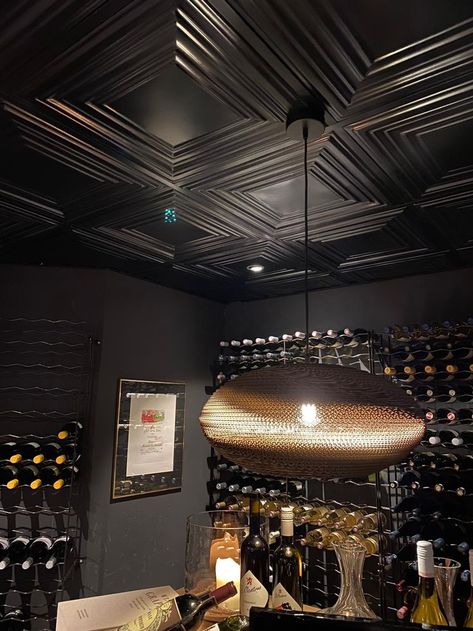 The black steel ceiling tiles from New York Ceiling Co. are robust and warm at the same time. And ideal as original ceiling decor. As in the interior this wine cellar. The metal ceiling tiles come not only in black, but also in copper, brass and other metallic decor. For every interior style the right ceiling tile. Want inspiration for your ceiling ideas? Then take a look at the website for all colors and patterns. The 3d tiles come in different patterns. Black Ceiling Tiles, Copper Ceiling Tiles, Suspended Ceiling Tiles, Ceiling Tiles Basement, Metallic Decor, Wine Cellar Basement, Metal Ceiling Tiles, Modern Restaurant Design, New House Bathroom