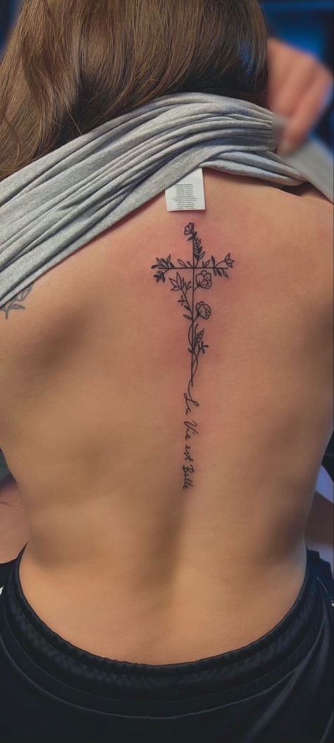 Back Tattoo With Meaning Women, Cross On Back Tattoo Woman, Flower Cross Spine Tattoo, Southern Spine Tattoos, Daisy Tattoo Spine, Spine Tattoos With Cross, Feminine Patriotic Tattoos, Back Tattoo Women Cross, Little Spine Tattoos