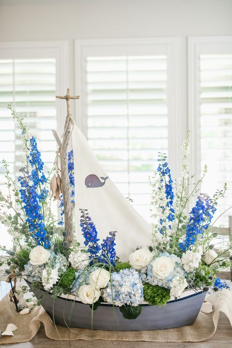 Boat Floral Arrangement, Ship Centerpiece Ideas, Boat Flower Arrangement, Sea Floral Arrangements, Nautical Baby Shower Centerpiece Ideas, Baby Boy Shower Flower Arrangements, Ocean Theme Flower Arrangements, Boy Baby Shower Flower Centerpieces, Ocean Floral Arrangements