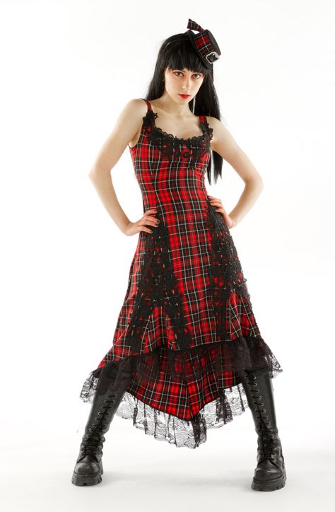 Edgy, alternative long punk dress with attitude in black and red mac tartan. Packed full of design, this dress features black plique detailing around the neckline and either side of the skirt, with a black lace hemline trim. There is a recessed zip fastening on the back. It is an ideal punk dress to create a stir at any party. Glam it up with one of our many complimentary fascinators or tartan accessories online. Punk Dresses, Red Tartan Dress, Celtic Fashion, Angel Clothing, Tartan Accessories, Punk Dress, Angel Outfit, Long Red Dress, Fashion Lingerie