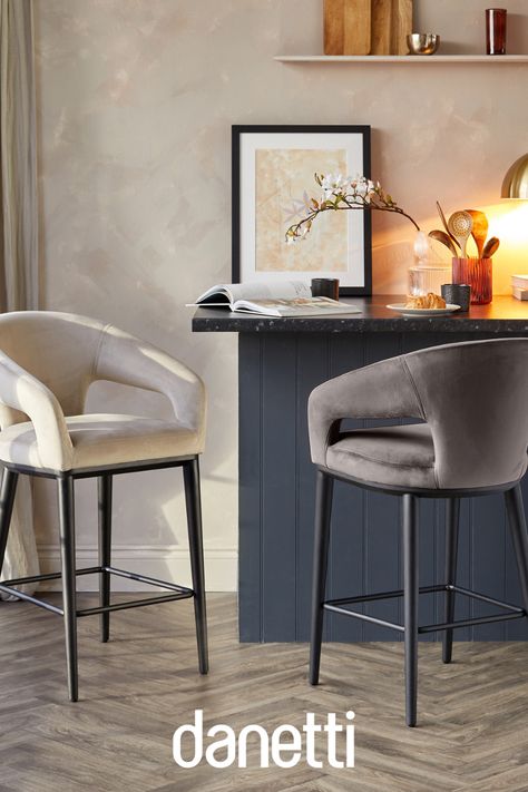 Relax with Coffee or Cocktails in ultimate comfort and style with the Heath Velvet Bar Stool. This sleek, modern armchair style bar stool is designed with generous seating and scooped arms for maximum comfort and support. With its high back detailing and key-hole sides for style, the Heath is the perfect choice for an elegant yet comfortable experience at your breakfast bar or kitchen island. Designed in the UK and exclusive to Danetti. High Chair For Kitchen Island, Bar Stools With Arms And Back, Tall Bar Stools With Back, Bar Stools At Kitchen Island, Breakfast Chairs Bar Stools, Modern Bar Stools Kitchen Island, High Chair For Kitchen, Kitchen Island Chairs With Back, High Stool Chairs