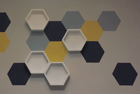 Painted hexagon wall art with shelves. #nursery #newbaby #wallart Nursery Colors Boy, Hexagon Wall Art, Baby Boy Nursery Colors, Hexagon Wall, Honeycomb Shelves, Trendy Baby Nursery, Wall Paint Designs, Unique Houses, Nursery Colors