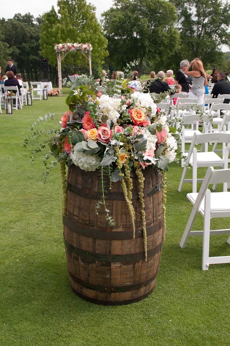 Whisky barrels full of draping flowers. Whisky Barrel Flowers, Barrel Wedding Decor Entrance, Whisky Barrel Wedding Decor, Barrel Flowers Wedding, Wine Barrel Flower Arrangements, Wine Barrel Flowers, Whiskey Barrel Flowers, Wine Barrel Wedding Decor, Barrel Wedding Decor