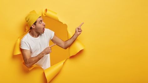 Impressed young man points away, shows d... | Free Photo #Freepik #freephoto #hand #student #wall #hat Wow Wallpaper, Salam Image, Advertising Video, Smart Casual Menswear, Hipster Looks, European Men, Yellow Clothes, Water Branding, Pointing Hand