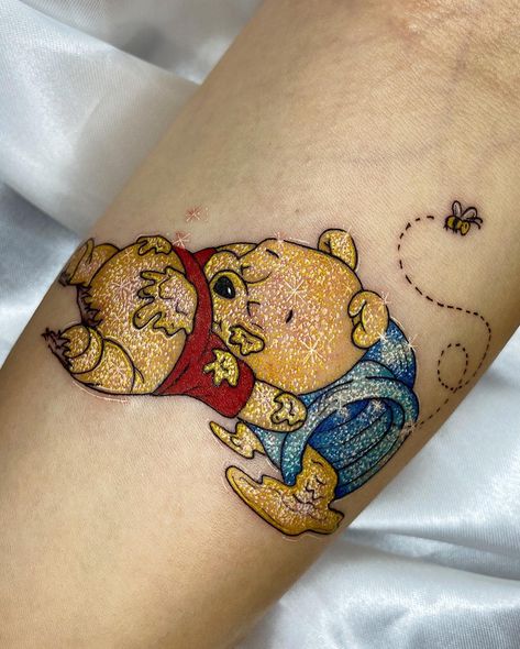 Glitter tattoos are body art that are created using a stencil and special glue to apply glitter to the skin. They are a popular form of body art, espe... Winnie The Pooh Tattoo Cover Up, Hogwarts Tattoos, Glitter Tattoo Ideas, Pokemon Sleeves, Glitter Tattoo Kit, Sparkle Tattoo, Bright Tattoos, Cartoon Tattoo, Retro Tattoos