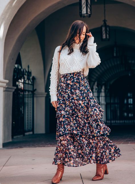 Sydne Style shows how to wear a maxi skirt for winter with chunky knits #turtleneck #maxiskirt #florals #knits @sydnesummer Turtleneck Maxi Skirt, Floral Maxi Skirt Outfit Winter, Floral Maxi Dress Winter Outfit, Long Skirt For Winter Outfits, Layered Midi Skirt, Crop Sweater Over Dress, How To Wear Skirts In Winter, Sweater Over Maxi Dress, Floral Dress Outfit Winter