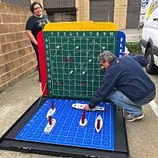 Giant Battleship Game - Event Party Rental Video Amusement California Giant Battleship Game, Battleship Float Ideas, Giant Battleship Game Diy, Battleship Game Decorations, Lifesize Board Games, Board Game Float Ideas, Board Game Parade Float Ideas, Battleships Game, Wedding Barrels