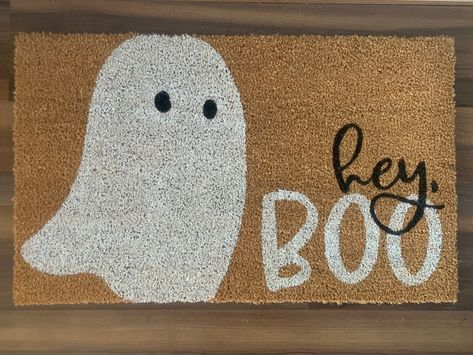 "Bring a friendly Halloween greeting to guests and trick-or-treaters with this \"hey, boo\" welcome mat.  Doormats are hand-painted with outdoor-rated paint. These natural coir doormats measure approximately 18\"x30\" in size and have non-slip backing. This mat is suitable for outdoor use but keeping it out of rain and direct sunlight will prolong the life of the design. Avoid saturating with water. Shake or sweep to clean. Listing includes one coir doormat only. Listing photos include display o