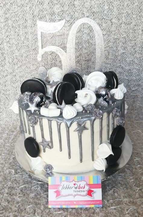 50th birthday cake with white buttercream frosting and silver chocolate ganache drips. Topped with black macarons, white meringue kisses, lindt chocolate balls and silver fondant stars and mini roses. With lasercut number 50 silver glitter topper Black White And Silver Cake Ideas, Cake Ideas For 50th Birthday Men, Black And Silver Cake Birthday For Women, Black White And Silver Birthday Cake, Birthday Cake White And Silver, Birthday Cake Black And Silver, Black And Silver Cake For Men, Black White And Silver Cake, Black And Silver Cakes Birthday