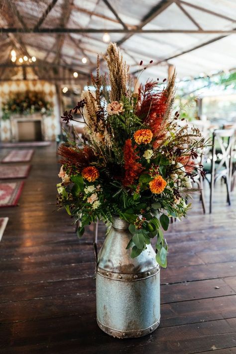 Vintage milk churn with orange, red and beige dried grass and flowers Orange And Red Wedding, Sage Green Wedding Flowers, Dried Wedding Flowers, Rustic Flower Arrangements, Grass And Flowers, Wedding Decor Rustic, Olive Wedding, Milk Churn, Green Wedding Flowers