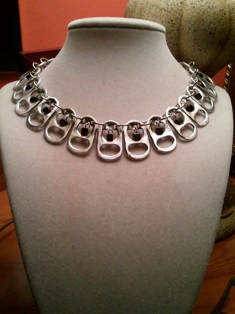 Made this necklace out of pull tabs off soda cans, connected them with jump rings and added little black beads to dangle in the center of each. Soda Can Jewelry Diy, Can Lid Necklace, Can Tab Jewelry, Can Tab Necklace, Trash Jewelry, Soda Tab Necklace, Recycled Dress Ideas, Tab Jewelry, Tab Necklace