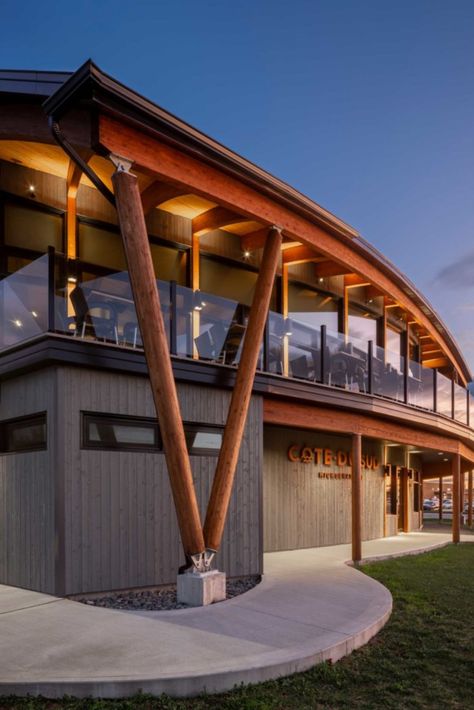 This microbrewery building is entirely made of glued laminated timber. This distinctive architecture gives the beams different profiles. The connectors hidden in the wood are therefore adapted to each of the beams. The exterior round glulam columns are reminiscent of ship masts. Photo credit : Stéphane Groleau. Wood Structure: Art Massif Beam And Column Structure, Wood Architecture Design, Ship Building Architecture, H Beam Structure, Timber Buildings Architecture, Mass Timber Structure, Heavy Timber Architecture, Wood Structure Detail, Column Design Exterior Architecture