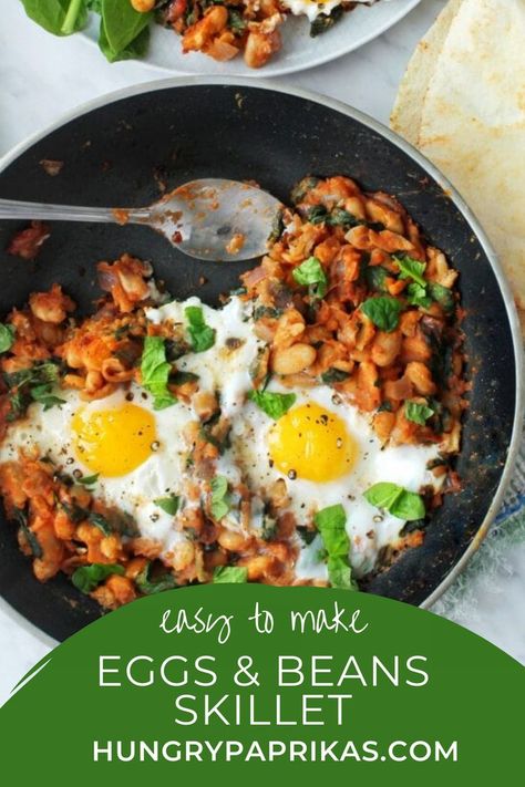 This beans and eggs breakfast or brunch skillet is a winner because just look at the ingredients list! Wholesome nutritious spinach and beans, cooked in a delicious tomato sauce with onions and garlic. And that dreamy egg yolk to mop up with a crusty piece of bread. What's not to love? | how to make eggs and beans skillet | brunch recipe Egg Beans Breakfast, Bean And Egg Recipes, Eggs And Beans Recipes, Beans Eggs Breakfast, Beans And Eggs Recipe, Eggs Rice And Beans Breakfast, Eggs And Beans Breakfast, Bean And Egg Breakfast, Bean Breakfast Recipes