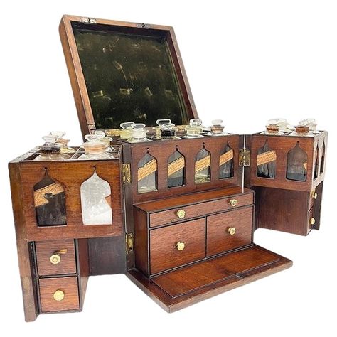 A 19th century English medicine chest by Clay and Abraham, Liverpool. A small antique mahogany medicine cabinet with brass handle dating from the early 19th century, which opens through the double doors to reveal an arrangement of bottles, with labels and contents, multiple drawers including weighing instruments and weights, mortar and pestle. A trade label on the bottles for Clay, Abraham Chemists, Liverpool. Their Shop on Bold Street The interior of the medicine chest has 14 compartments with Dream Home Library, Antique Medicine Bottles, Glass Bottle With Stopper, Medicine Chest, Antique Glass Bottles, Apothecary Cabinet, Medicine Boxes, Vintage Medical, Medicine Bottles