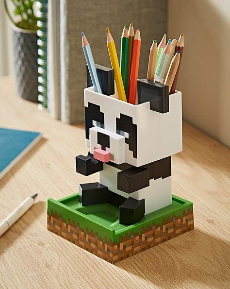 Add a touch of pixelated style to your home with this Panda Desktop Tidy. The 15cm (5.9) tall desktop organiser is shaped like the Panda from Minecraft. With an integrated stationery pot, trinket tray and universal phone stand, the possibilities for using your Panda are endless. The Panda Desktop Tidy will make a cute addition to your desk. Minecraft fans will love using it. Kids Desk Tidy, Desk Minecraft, Minecraft Panda, Minecraft Accessories, Minecraft Diy Crafts, Desktop Organiser, Minecraft Toys, Pokemon Halloween, Diy Minecraft