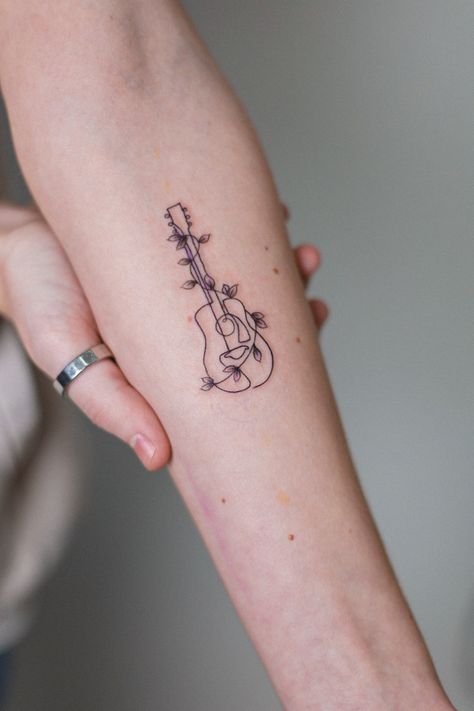 Mini Forearm Tattoo, Guitar Tattoo Forearm, Music Tattoo For Women, Fineline Guitar Tattoo, Guitar And Music Tattoo, Cute Guitar Tattoos, Pretty Music Tattoos, Line Art Guitar Tattoo, Ukulele Tattoo Ideas