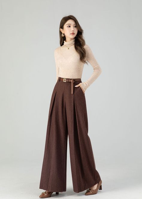 "Carefully crafted from luxurious wool, these full-length trousers provide the ultimate blend of fashion and warmth. Their flattering wide-leg design adapts to various occasions, and the deep chestnut brown shade exudes timeless sophistication. Whether you're heading to the office or a festive gathering, these wool pants ensure you stay stylish and snug. Embrace the beauty of the season with this must-have piece designed to keep you fashion-forward and cozy. DETAILS: * 30% wool blend, 40% fiber and polyester, 40% nylon * Polyester Lining * Two side pockets * Zipper and button front closure * Pleated detail * High waisted pants * Wide leg pants * Perfect for Winter, autumn * Dry clean MODEL SIZE Bust 85 cm(33.4\") Waist 67 cm(26.7\") Height 168cm (5' 6\") She wears size XS CUSTOM MADE SERVI Wide Leg Pants Wedding Guest, Dark Brown Dress Pants Outfit, A Line Trousers, Winter Trousers Women, Pleated Pants For Women, Office Wide Leg Pants, Wide Leg Pants For Fall, Brown Trousers Women, Chocolate Brown Pants Outfit