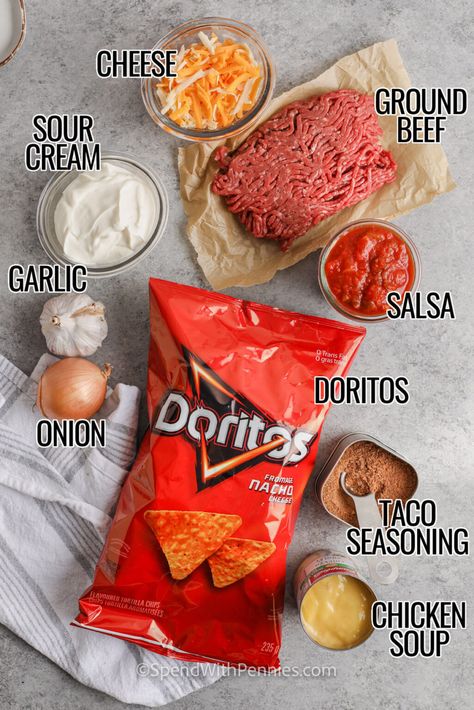 Layered Dorito Casserole is an easy family favorite recipe! Lean ground beef is seasoned with taco seasoning and salsa to create a delicious filling. Layers of Doritos create a delicious casserole which is then topped with our favorite taco-inspired toppings! #layereddoritoscasserole #doritocasserole #tacocasserolewithdoritos #spendwithpennies Casserole Recipes Doritos, Dorito Bake Casserole, Nachos Recipe Doritos, Dorito Meals, Ground Beef And Doritos Recipes, Easy Dorito Casserole Hamburger, Dorito Taco Casserole Bake, Dorito Casserole Recipes, Taco Bake With Doritos