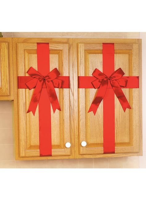 CABINET RIBBONS ADD HOLIDAY CHEER TO YOUR KITCHEN!Wrap these bright red ribbons and decorative bows around almost any cabinet door for a ornamental accent that takes up no space. Adjustable ribbons attach securely with hook-and-loop closures. Set of 4 fit cabinets up to 42"L, Each ribbon measures 88"L x 3"W. Nylon/polyester. Christmas Cabinets, Kitchen Wrap, Easy Christmas Decorations, Christmas Kitchen Decor, Christmas Décor, 12 December, Decorative Bows, Christmas Bow, Indoor Christmas Decorations