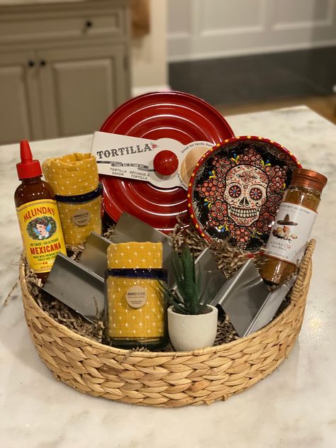 Love Tacos and Mexican food ? Check out this awesome gift basket perfect for the taco lover.  Handled woven serving tray is filled with stainless steel Taco holders, Decorative chip dish , tortilla saver , Adobo spice blend, Melissa's famous hot sauce, margarita glasses, dinner napkins and decorative succulent. Delivered wrapped in cellophane with personalized gift card Perfect for bridal shower, new homeowner or best friend gift Bagel Gift Basket Ideas, Diy Thank You Gift Baskets, Personalized Gifts For Christmas, Taco Basket Raffle, Taco Kit Gift, Taco Night Basket Ideas, Taco Themed Gifts, Fun Gift Basket Ideas For Women, Creative Raffle Baskets