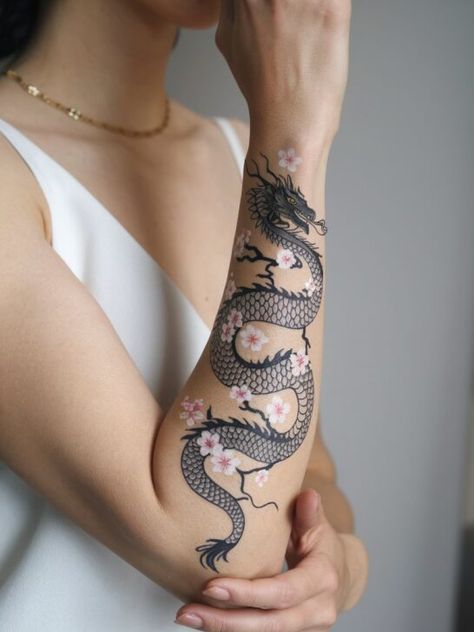 The 20 Most Stunning Asian Dragon Tattoos That Will Leave You Speechless Dragon Tattoo For Women Japanese, Karate Tattoos For Women, Peaceful Dragon Tattoo, Year Of The Dragon Tattoo For Women, Dragon Wrapped Around Wrist Tattoo, Asian Dragon Tattoo For Women, Chinese Dragon Tattoos For Women, Feminine Dragon Tattoo For Women, Year Of The Dragon Tattoo