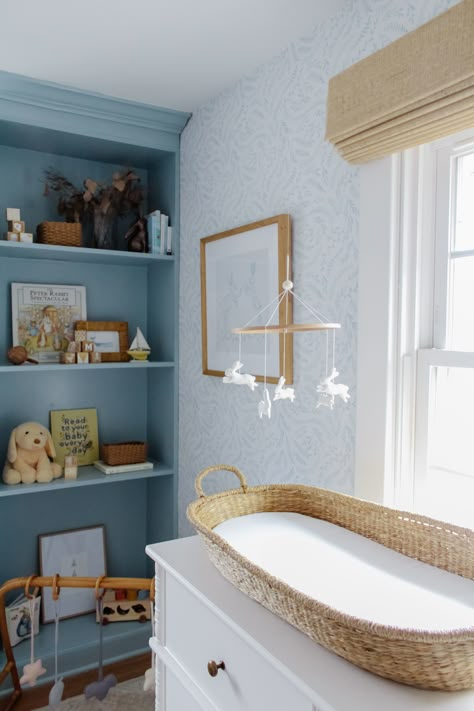 Blue And Rattan Nursery, Coastal Nursery Wallpaper, Classic Blue And White Nursery, California Coastal Nursery, Blue And White Nursery Girl, Feminine Blue Nursery, Cornflower Blue Nursery, Coastal Grandma Nursery, Light Blue Girls Nursery