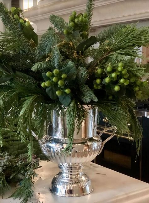 Christmas Topiaries, Holiday Floral Arrangements Christmas, Champagne Bucket Christmas Decor, Holiday Greenery Arrangements, Flower Arrangements In Vase, Christmas Greenery In Vase, Christmas Greens Arrangements, Greenery Floral Arrangements, Champagne Bucket Decor