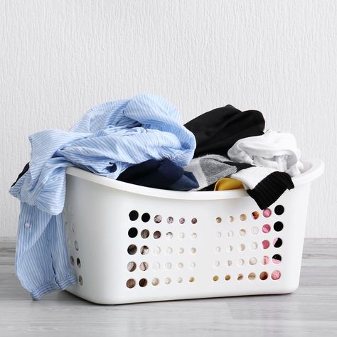 Basket with dirty laundry on floor against light wall Habit Stacking, Laundry Symbols, Wash And Fold, Dry Cleaning Services, Cleaning Tricks, Doing Laundry, Laundry Hacks, Dirty Laundry, Good Housekeeping