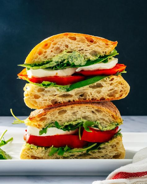 This Caprese sandwich is a stunning crowd pleaser! Layer tomatoes, mozzarella and pesto aioli for a splash of flavor. #capresesandwich #caprese #sandwich #summer #summerrecipe #fastdinner #easydinner #picnicrecipe #summerdinner Caprese Sandwich Recipe, Italian Caprese Salad, Pesto Aioli, Tomato Caprese, Caprese Sandwich, Pesto Cheese, Tomatoes Mozzarella, Easy Chicken Breast, Grape Salad