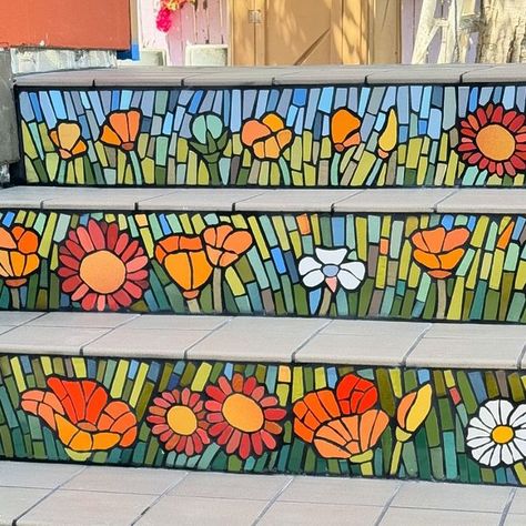 Wilma Marianne Wyss on Instagram: "Mosaic steps grouted. Feels good to have this sweet project completed. Thank you so much @ahc_oakland for this great opportunity to create a vibrant and cheerful mosaic for the new home for your art center. May the neighborhood children coming to the art center have a joyful spring in their feet as they the walk up the stairs! 👟🤩👟 #mosaiccommission #outdoormosaic #mosaicsteps #westoaklandisbeautiful #bayareaart #bayareamosaic #eastbaymosaic #wilmawyss #mosaic #oaklandnativeplants #oaklandart" Mosaic Tile Steps, Mosaic Porch Steps, Mosaic Stairs Outdoor Front Steps, Mosaic Stair Risers Outdoor, Mosaic Stair Risers, Mosaic Tile Stair Risers, Mosaic Stairs, Tile Steps, Stair Risers