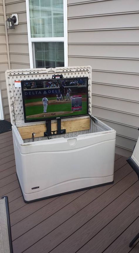 I wanted a TV on the deck. Converted a deck box to hold the TV and used a swing away TV mount turned on its side to fold the TV down into the deck box when not in use and to protect from the weather. Used a 2x6 board lag bolted from behind the box to support the TV mount Deck Tv Outdoor Tv Cabinet, Tv Outside Patio Outdoor Tv Cabinet, Covered Deck Tv Ideas, Tv On Back Porch, Small Patio Tv Ideas, Garage Tv Mount, Outdoor Tv On Deck, Diy Outdoor Tv Stand Ideas, Hot Tub Tv Ideas