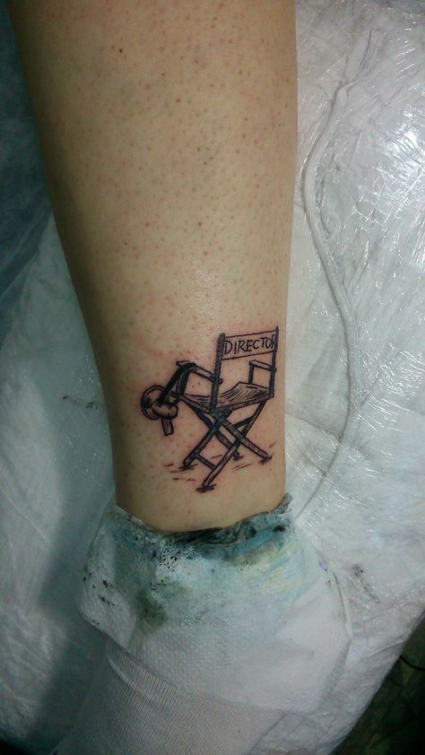 director chair tattoo simple tattoo minimal tattoo Cinematic Tattoo Ideas, Director Chair Tattoo, Tattoo Ideas Theatre, Chair Tattoo Design, Movie Scene Tattoo, Director Tattoo, Movies Tattoo Ideas, Theatre Tattoo Ideas, Film Tattoo Ideas