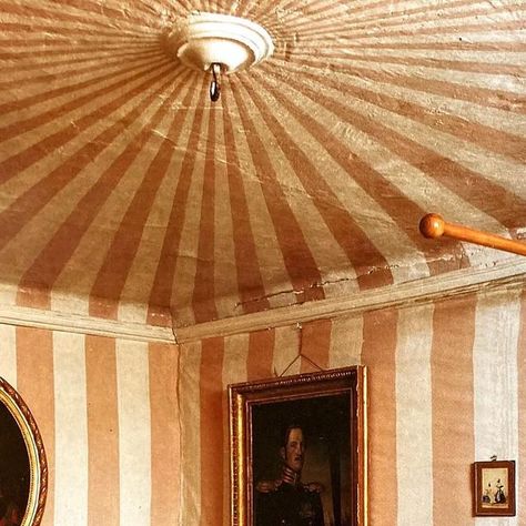 Toby Worthington on Instagram: "Why don’t you…paint wide stripes on your walls and ceiling, as done here in the early 1800s at the Rilax estate in Finland? It helps to have a ceiling that is vaulted— or that has, as seen here, a shallow cove that is carried onto another plane. Then you’re good to go. Many years ago I encountered a room with similar architectural features to this one. The walls were white; but the ceiling was painted in a midnight blue, stencilled with tiny gold stars. And very charming it was, too. #militarytent #paintedstripes  #worldofinteriors  #finnishhouses" Stripes On Ceiling, Painted Ceiling Stripes, Striped Ceiling Paint, Painted Ceilings Bedrooms, Stars Painted On Ceiling, Painted Ceilings, Painted Ceiling Ideas, Handpainted Striped Wall, Stripes Wall Paint