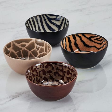 This Amari Dinnerware Bowl Set features four animal print designs: cheetah, zebra, tiger, and giraffe, on a distinctive reactive glaze finish. Due to the nature and hand-crafted qualities of reactive glaze, no two pieces are exactly alike and will exhibit unique variations in color and pattern. Product may slightly differ from image shown.• 12-piece set, service for 4, includes 4 each 8-1/2 inch dinner bowl with a 38-fluid ounce capacity, 6 inch pasta bowl with a 25-fluid ounce capacity, and a 9 Ceramic Plate Set Dinnerware, Kitchen Apt Decor, Cheetah Print Living Room Decor, Dishwear Sets Dinnerware, Dish Sets Dinnerware Unique, Cute Plates And Bowls, Unique Dishware, Cool Bowls, Funky Kitchen Decor