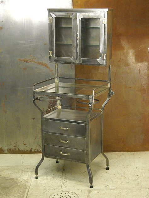 VINTAGE CABINET: A worn look will only enhance the sense of intrigue. Crafted of steel and glass, the Vintage Dentist Cabinet below offers tabletop storage as well as cabinet space. Medical Cabinet Vintage, Vintage Dental Cabinet, Dentist Cabinet, Vintage Dentist, Vintage Medical Cabinet, Pharmacy Cabinet, Vintage Metal Cabinet, Vintage Pharmacy, Metal Cabinets