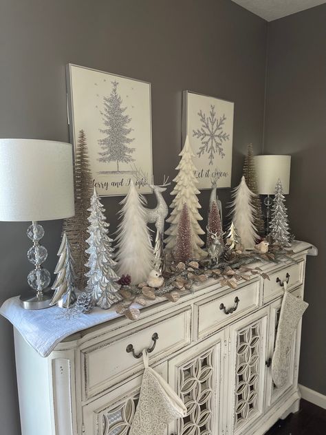 Grey Christmas Decorations, Buffet Decorated For Christmas, Silver Deer Christmas Decor, Dresser Christmas Decorations, Christmas Decor Ideas For Buffet Table, Gold Silver And White Christmas Decor, Christmas Decor Ideas Silver And White, Christmas Decor For Buffet, White Buffet Table Ideas Decor