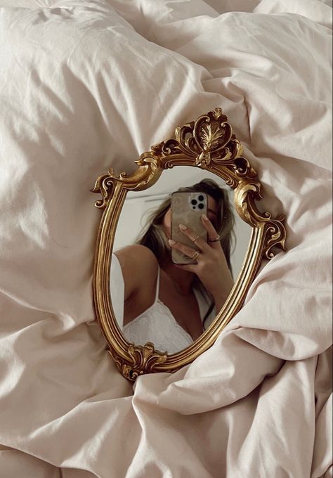 Small gold mirror selfie idea inspiration inspo aesthetic bed comforter pink blanket plain background antique unique black rings jewelry  white lace bodysuit bralette stylish style fashion jacket shacket sweater button down long stick on fake nails casual blush cool it girl instagram influencer insta blonde long hair money pieces balayage classy sophisticated cute photography photoshoot pose idea necklace strap lingerie dress skirt jeans midi mini maxi outfit summer spring 2022 nyc New York City Small Mirror Selfie Aesthetic, Small Mirror Selfie Poses, Small Mirror Selfie, Bed Mirror Selfie, Blush Pink Comforter, Bed Background, Crib Diy, Mirror Selfie Idea, Filler Pics